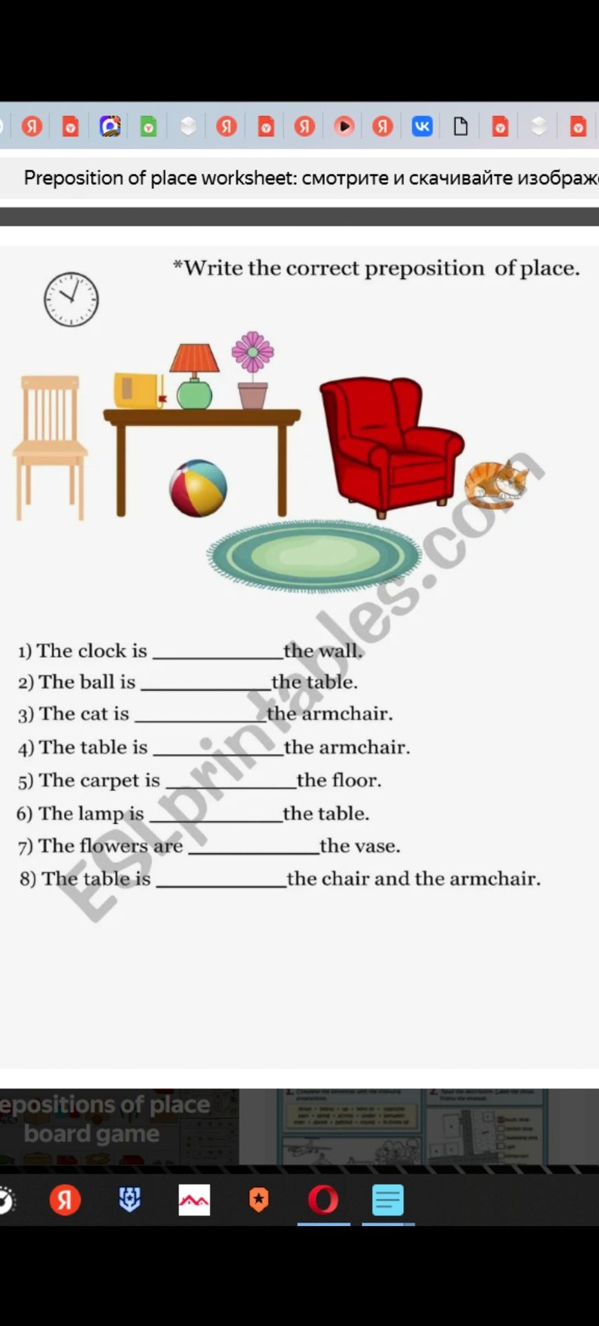 Фото задания: 1) The clock is _______ the wall. 2) The ball is _______ the table. 3) The cat is _______ the armchair. 4) The table is…
