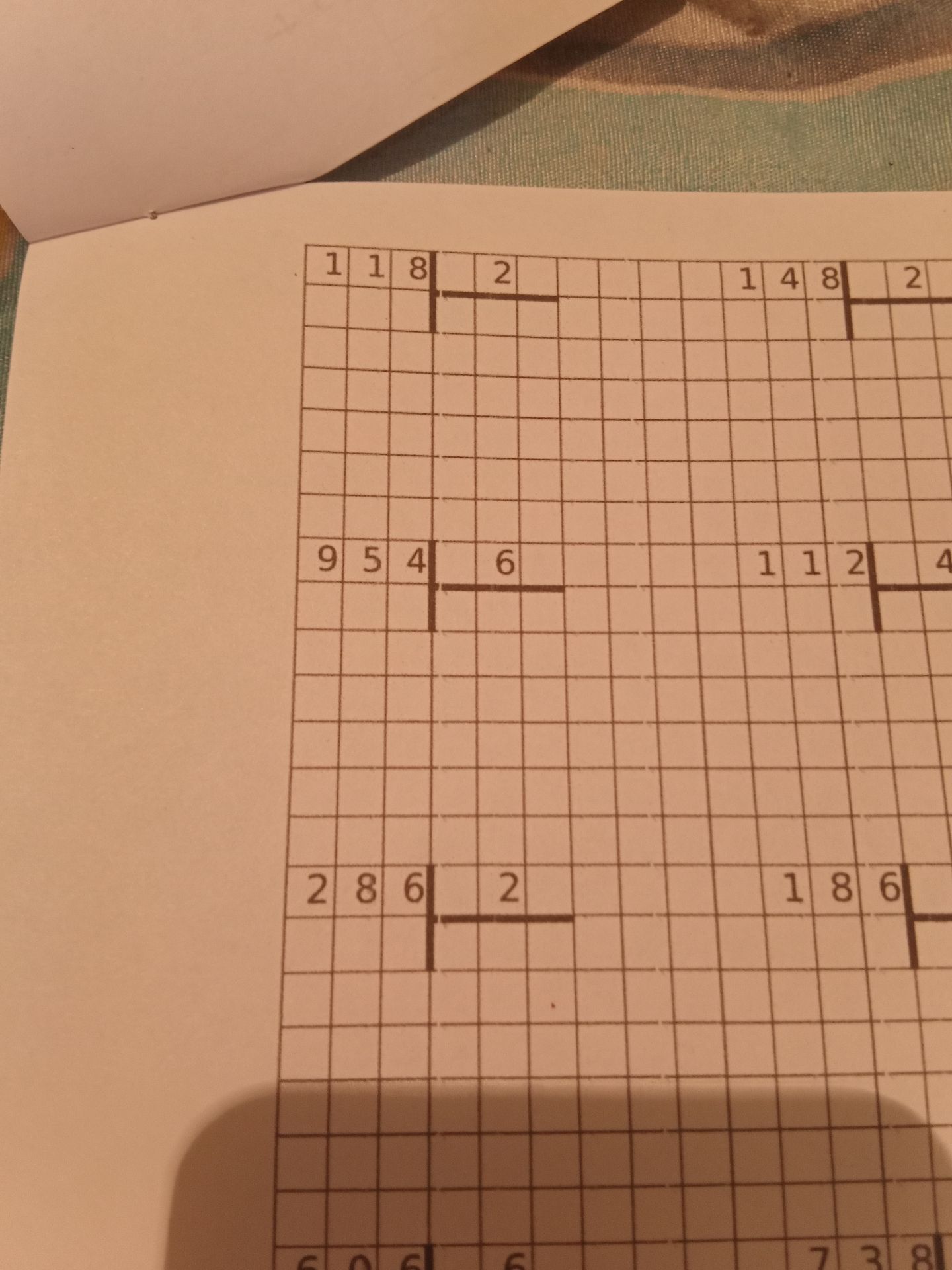 Фото задания: Fill in the grid based on the provided numbers and constraints.