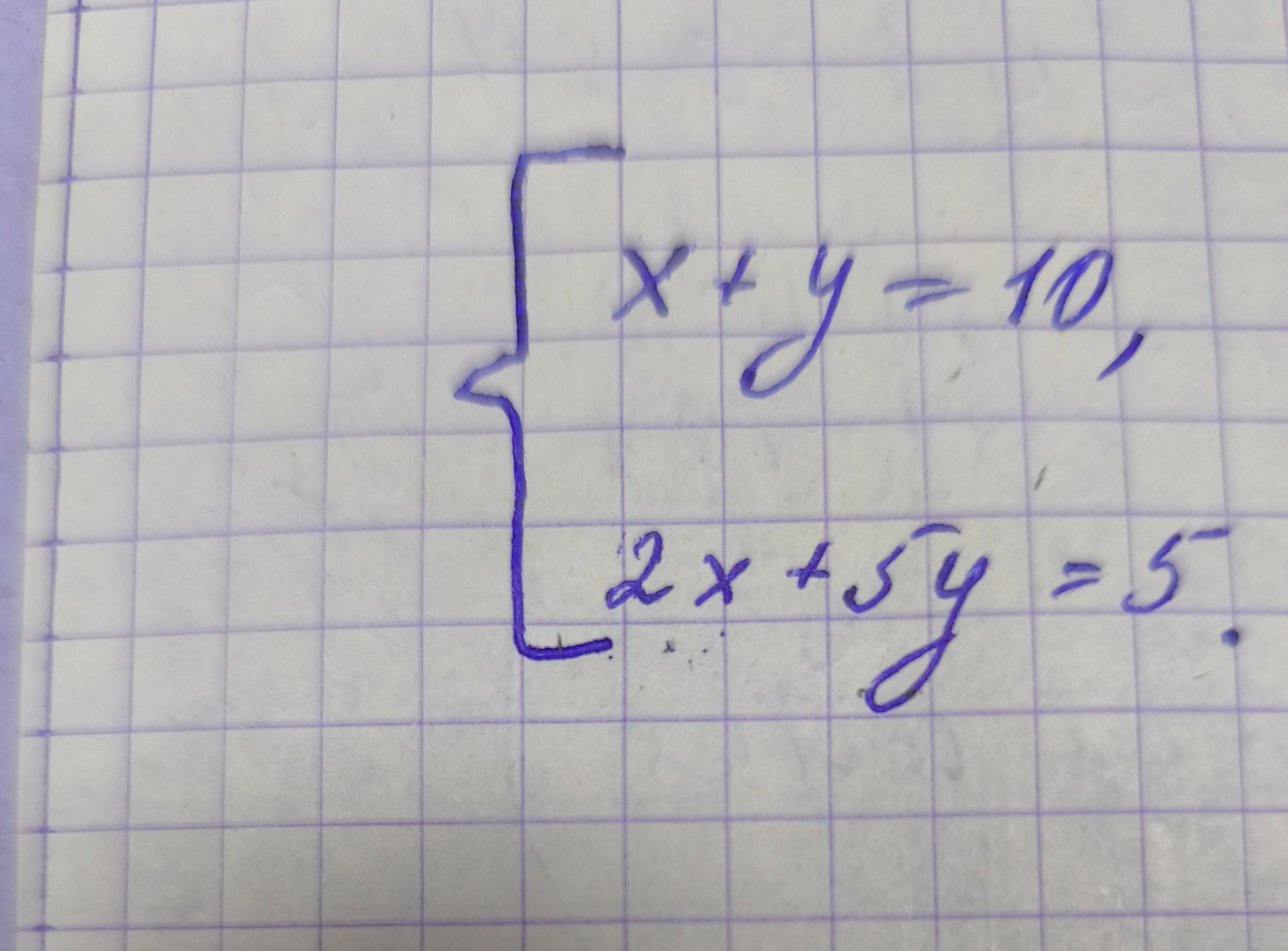 Фото задания: Solve the system of equations: $\begin{cases} x + y = 10 \\ 2x + 5y = 5 \end{cases}$