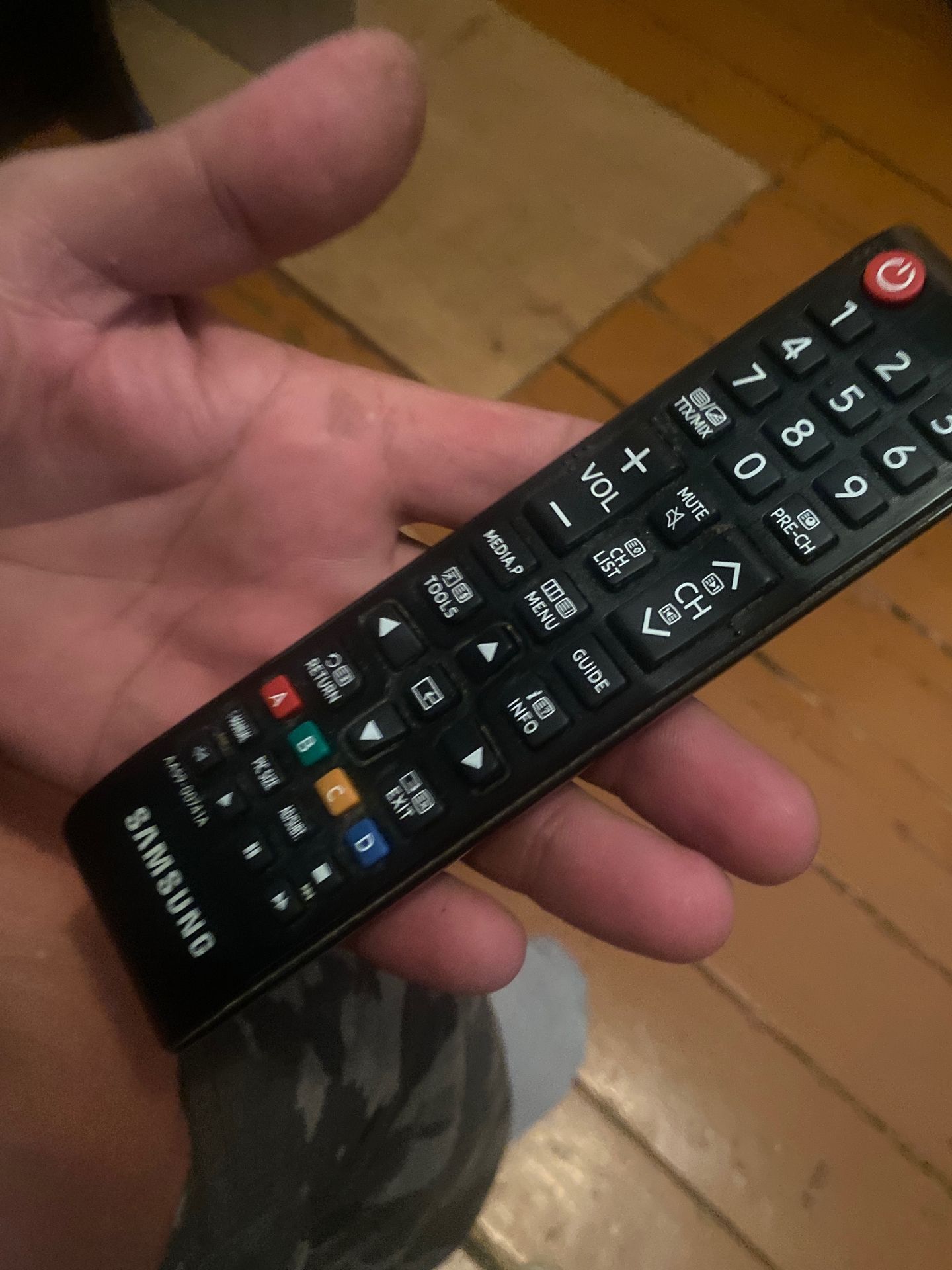 Фото задания: Please identify all visible buttons and their functions on the remote control.