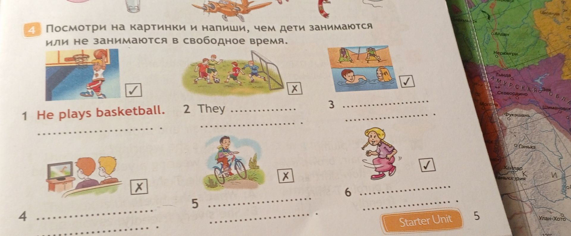 Фото задания: Look at the pictures and write what children do or do not do in their free time. 1 He plays basketball. 2 They [picture: play…