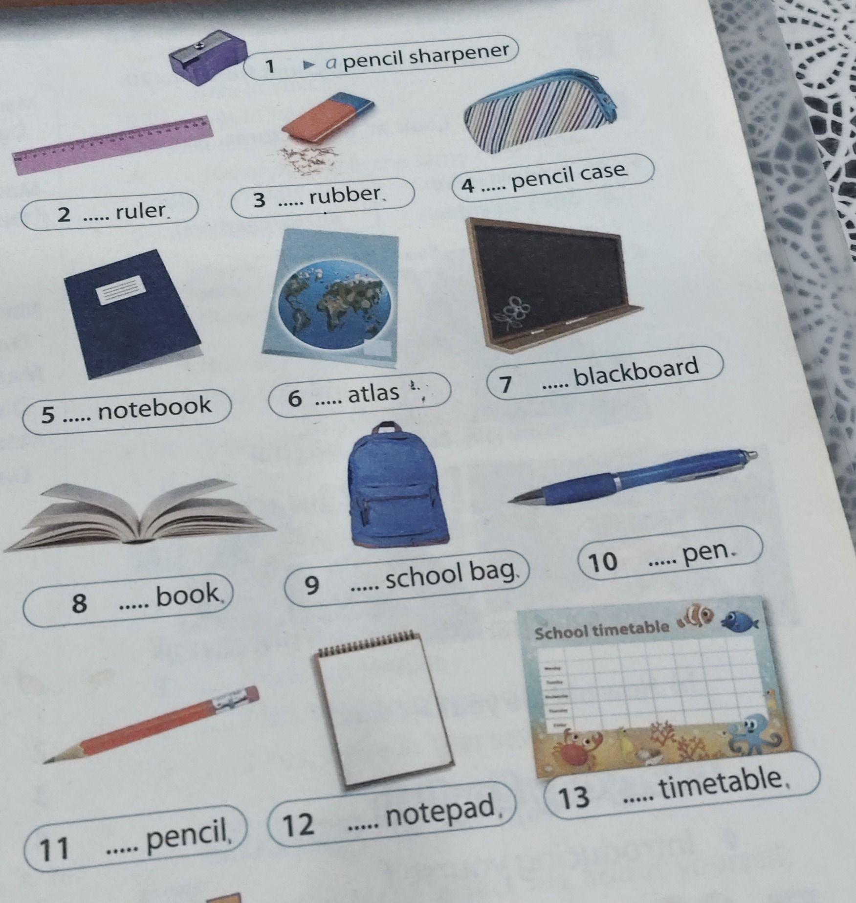 Фото задания: Complete with a or an: 1. a pencil sharpener; 2. ..... ruler; 3. ..... rubber; 4. ..... pencil case; 5. ..... notebook; 6.…