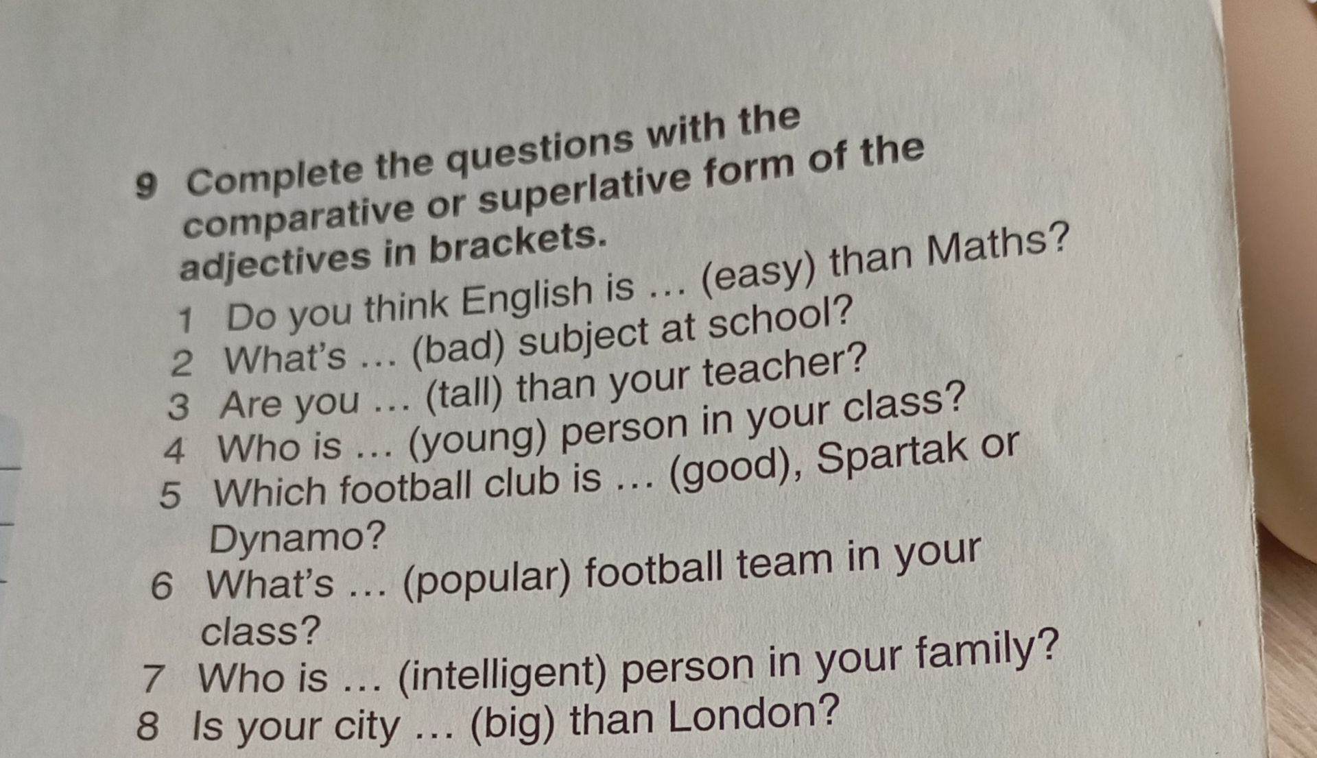 Фото задания: 9 Complete the questions with the comparative or superlative form of the adjectives in brackets. 1 Do you think English is…