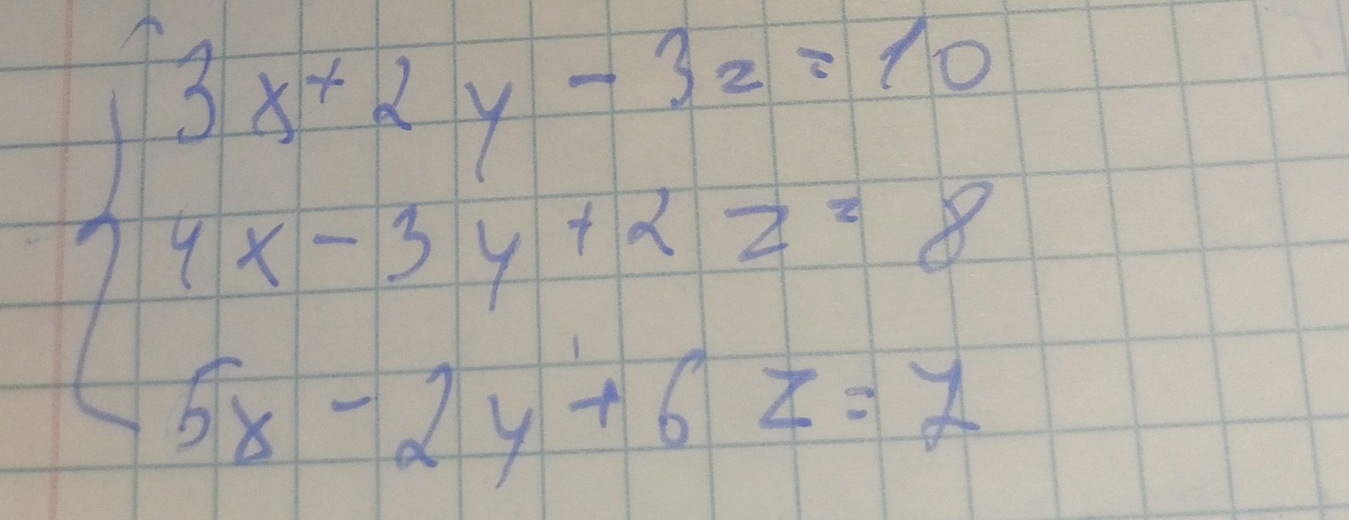 Фото задания: \(\begin{cases}3x+2y-3z=10,\\4x-3y+2z=8,\\5x-2y+6z=7.\end{cases}\)