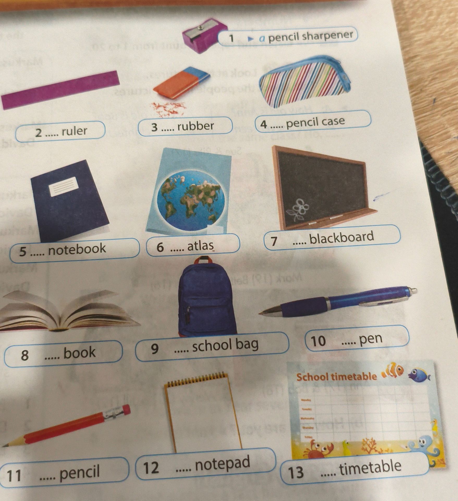 Фото задания: Complete the phrases: 2. … ruler; 3. … rubber; 4. … pencil case; 5. … notebook; 6. … atlas; 7. … blackboard; 8. … book; 9.…