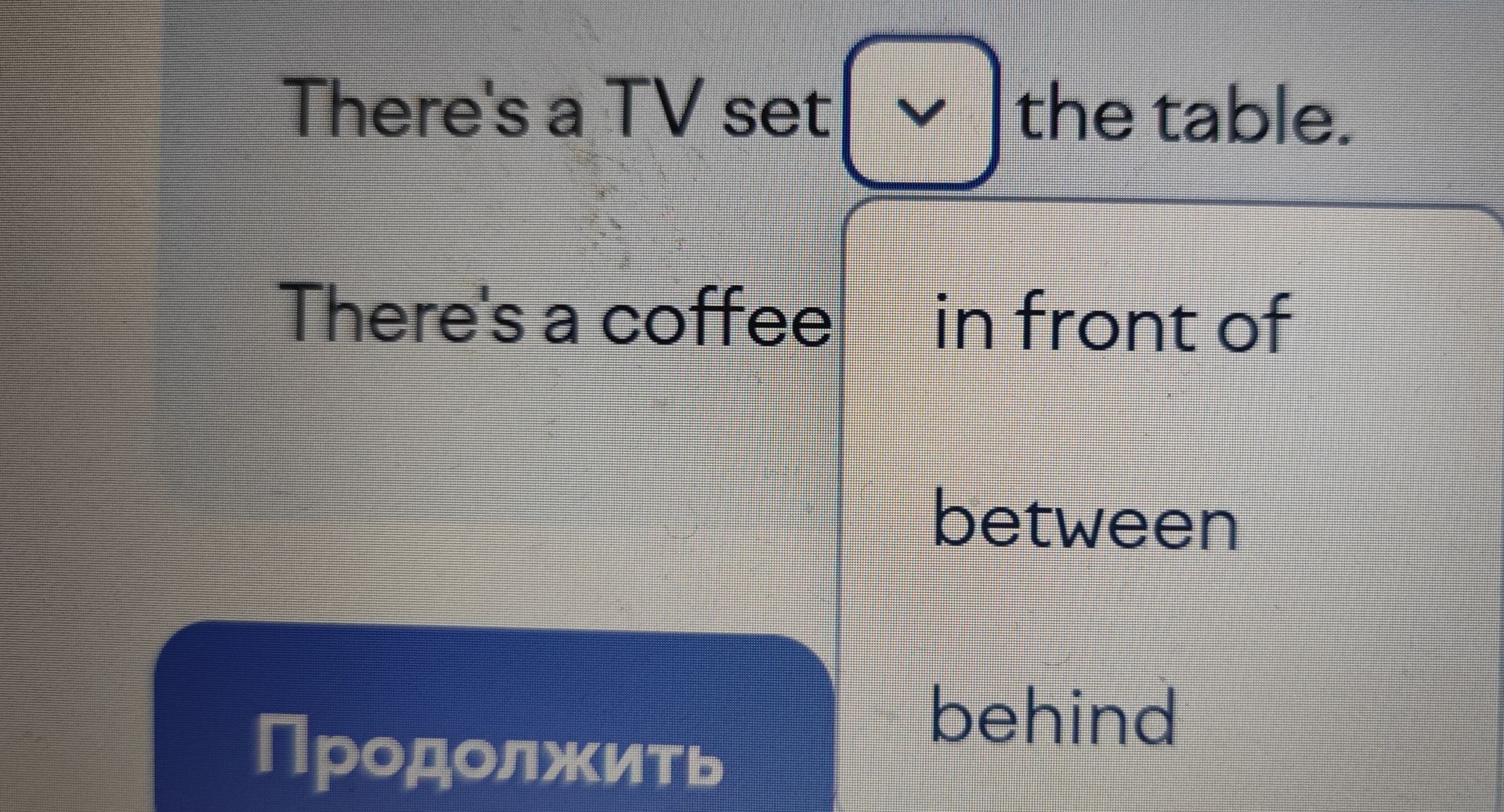 Фото задания: There's a TV set ___ the table. Варианты: in front of, between, behind.